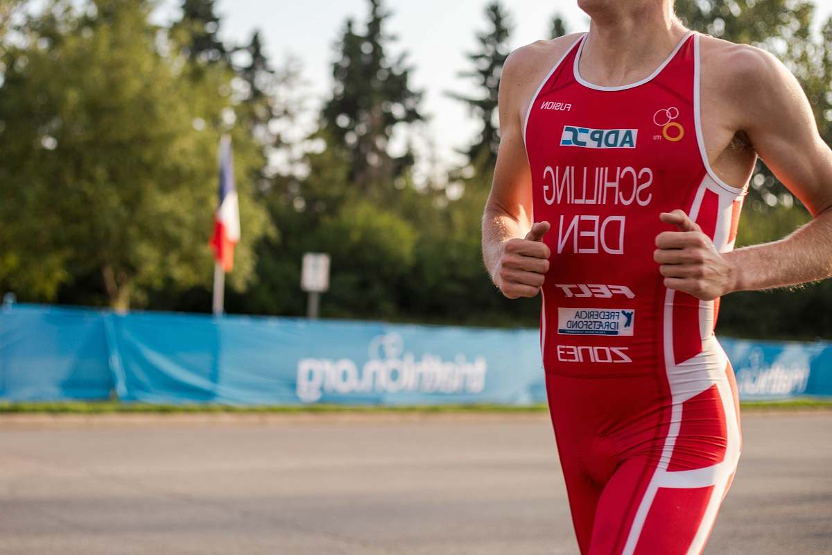 person man wearing red suit running on road people