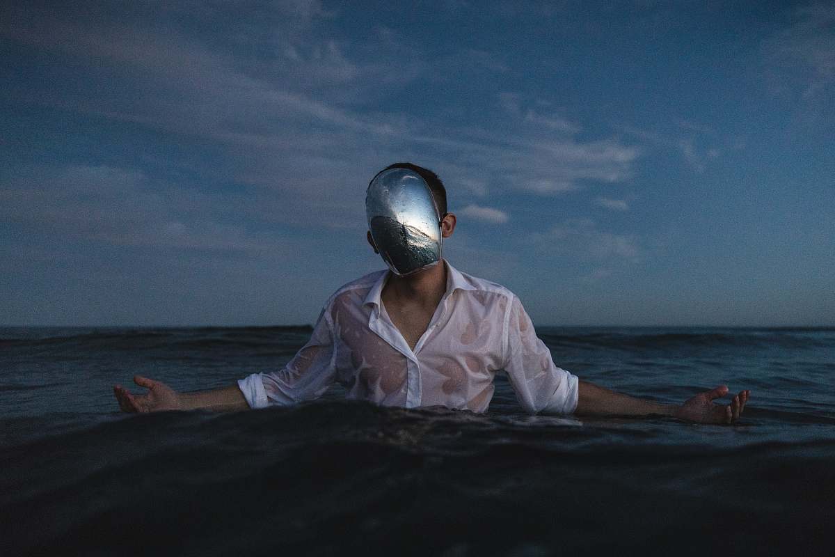 person man wearing white dress shirt standing on body of water people