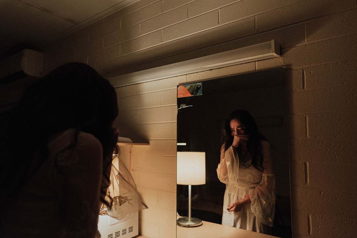 person woman crying in front of mirror human