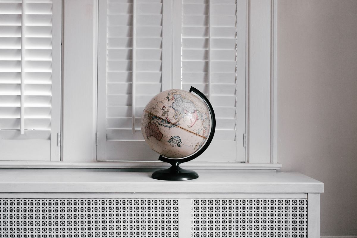 beige desk globe on white desk