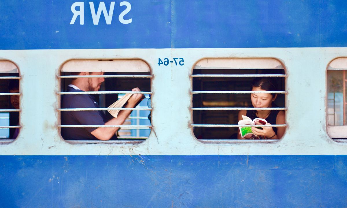 man and woman sitting on train