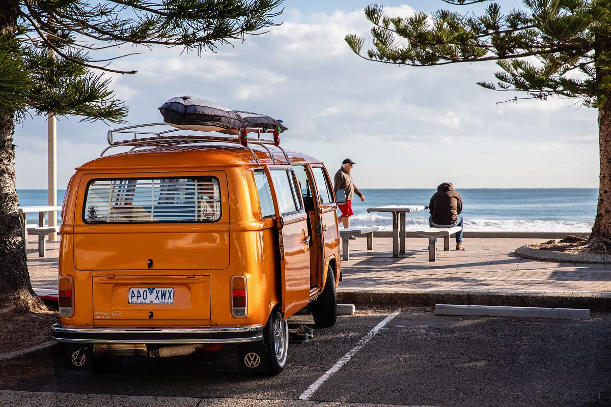 orange van park beside tree