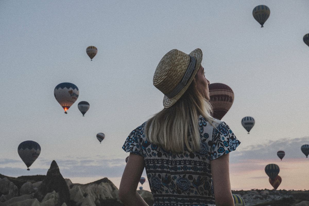 woman watching hot air balloons