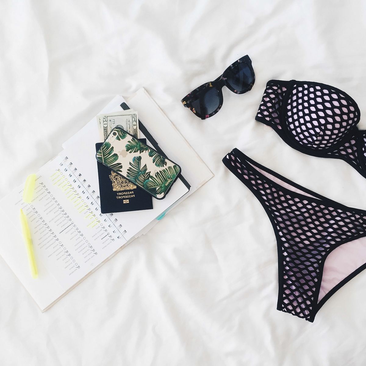 women's black-and-pink bikini on whit textile