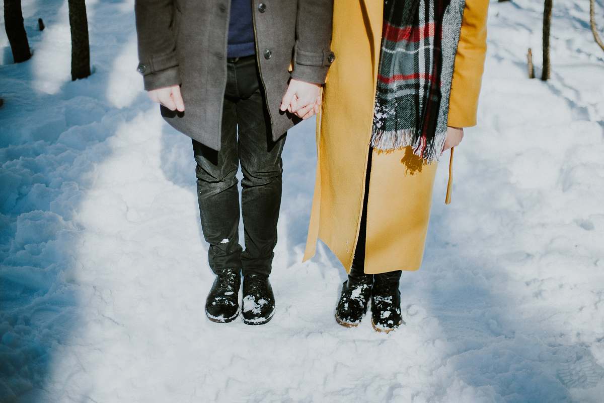 snow person standing beside each oter couple