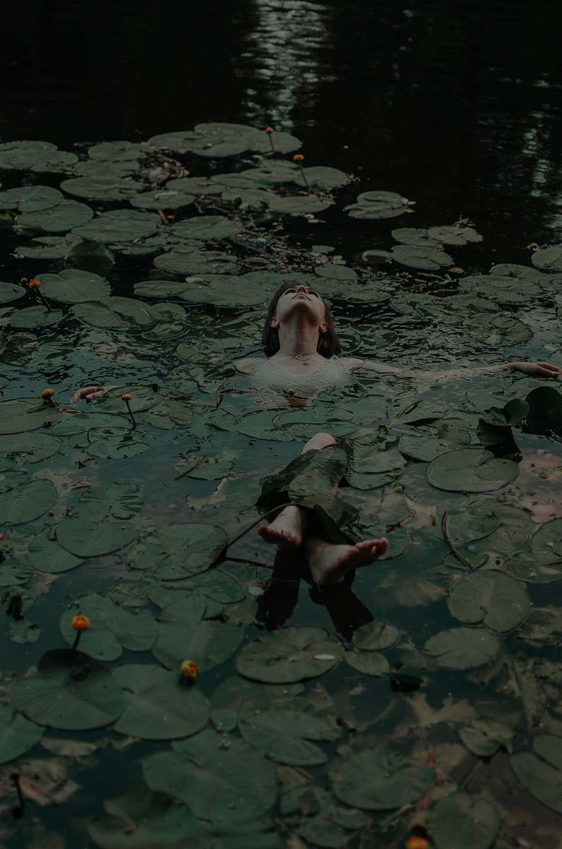 plant woman lying on body of water lily