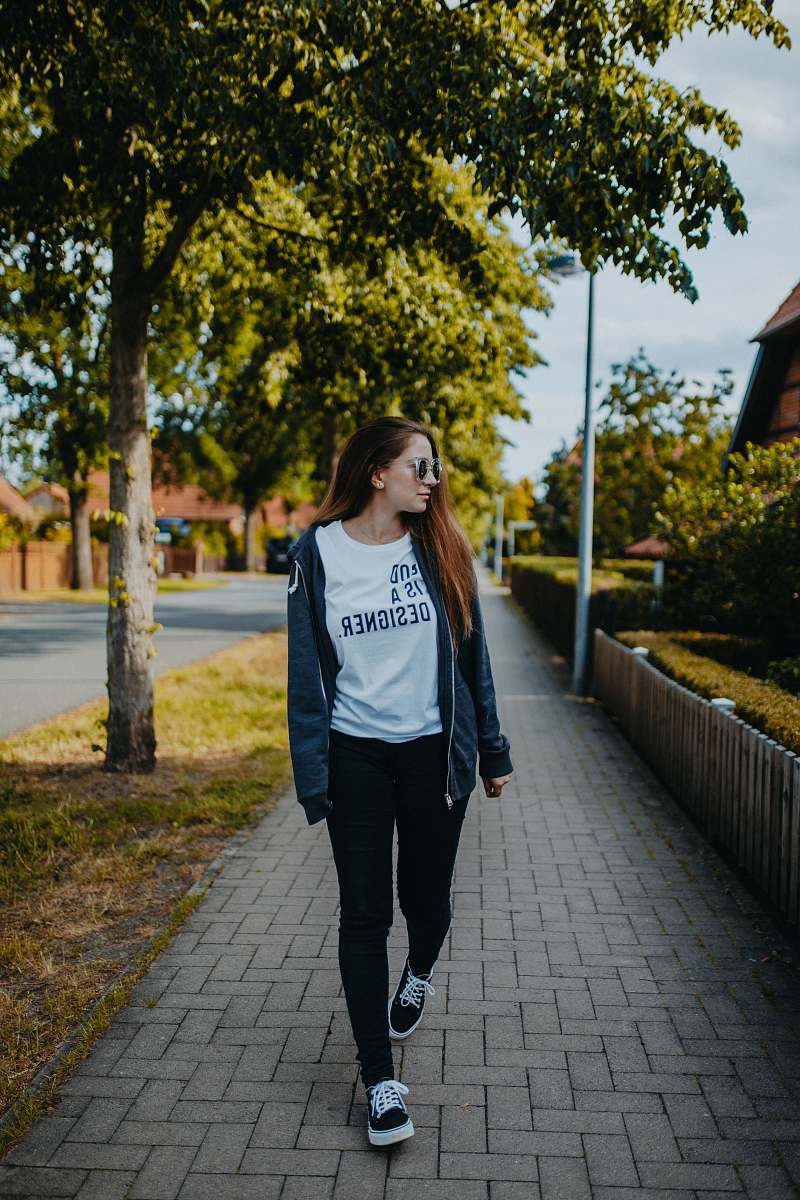 sleeve shallow focus photo of woman in black full-zip jacket and pants apparel