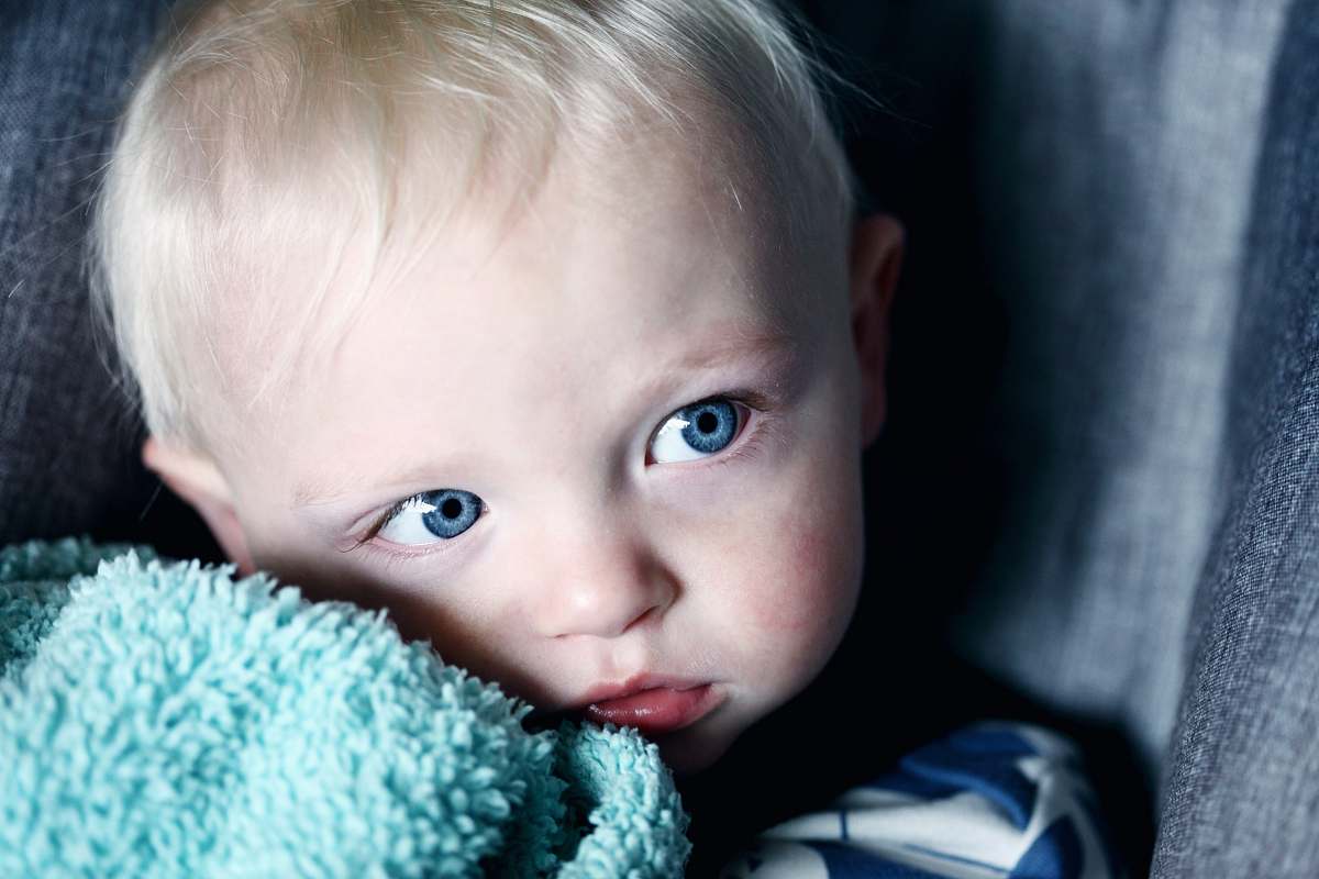 person baby beside green textile people
