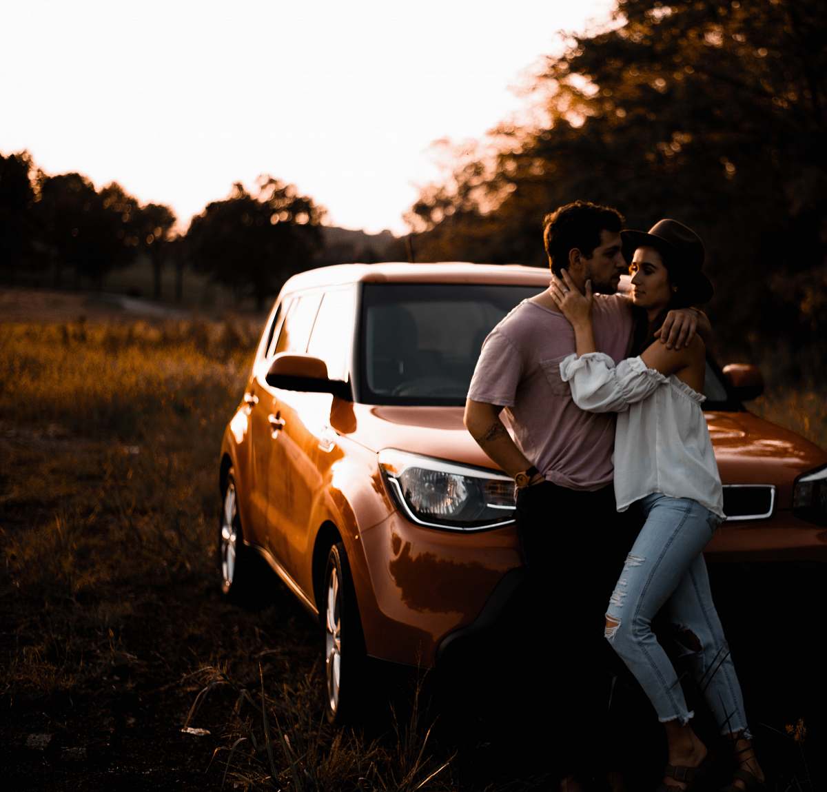 person couple learning on brown SUV during s car