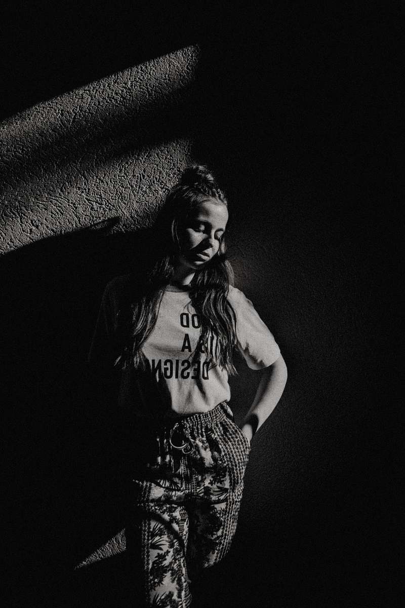 person grayscale photography of girl standing black-and-white