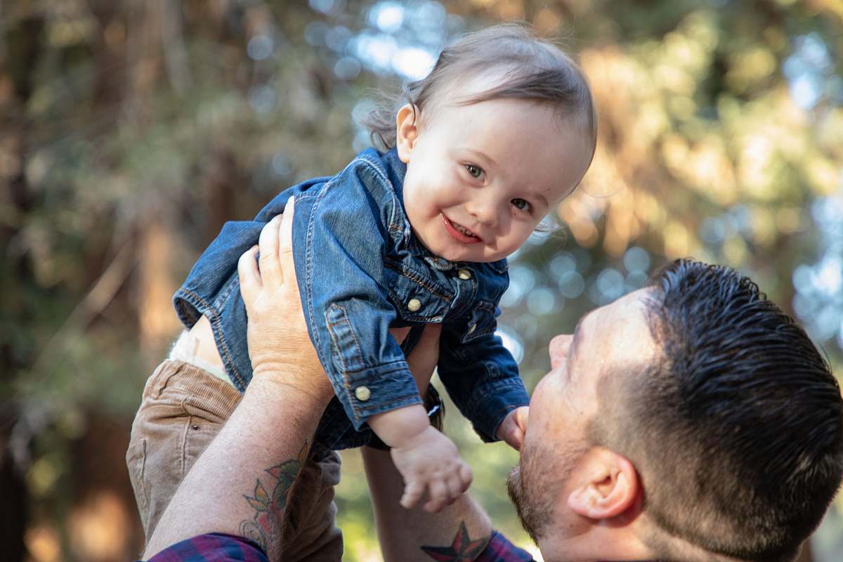 people man carrying baby person
