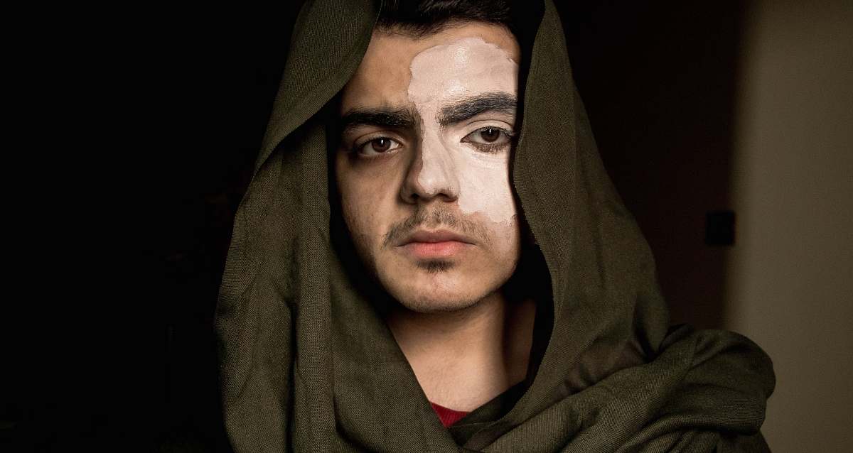 person man in black hoodie on focus photography face