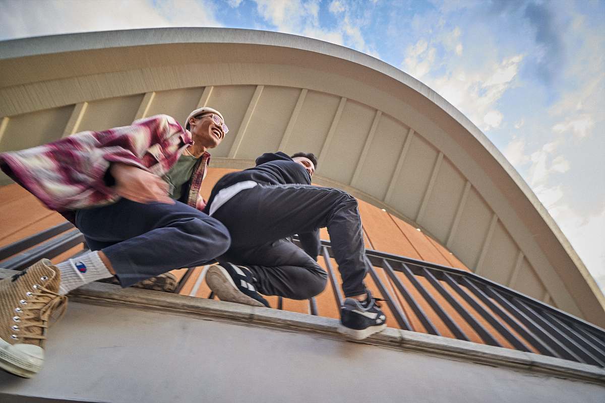 person two men hanging on railings architecture