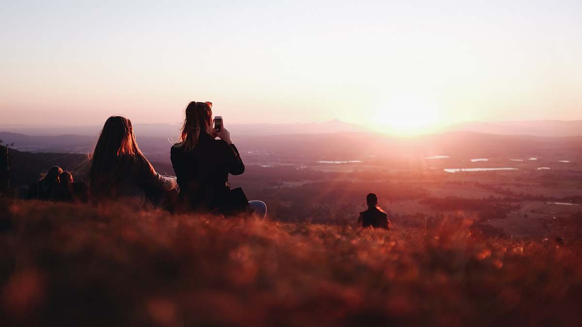person two person sitting on field nature
