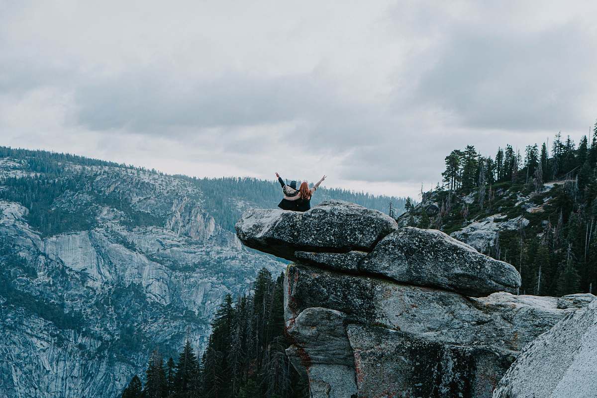 outdoors two people standing on rock cliff
