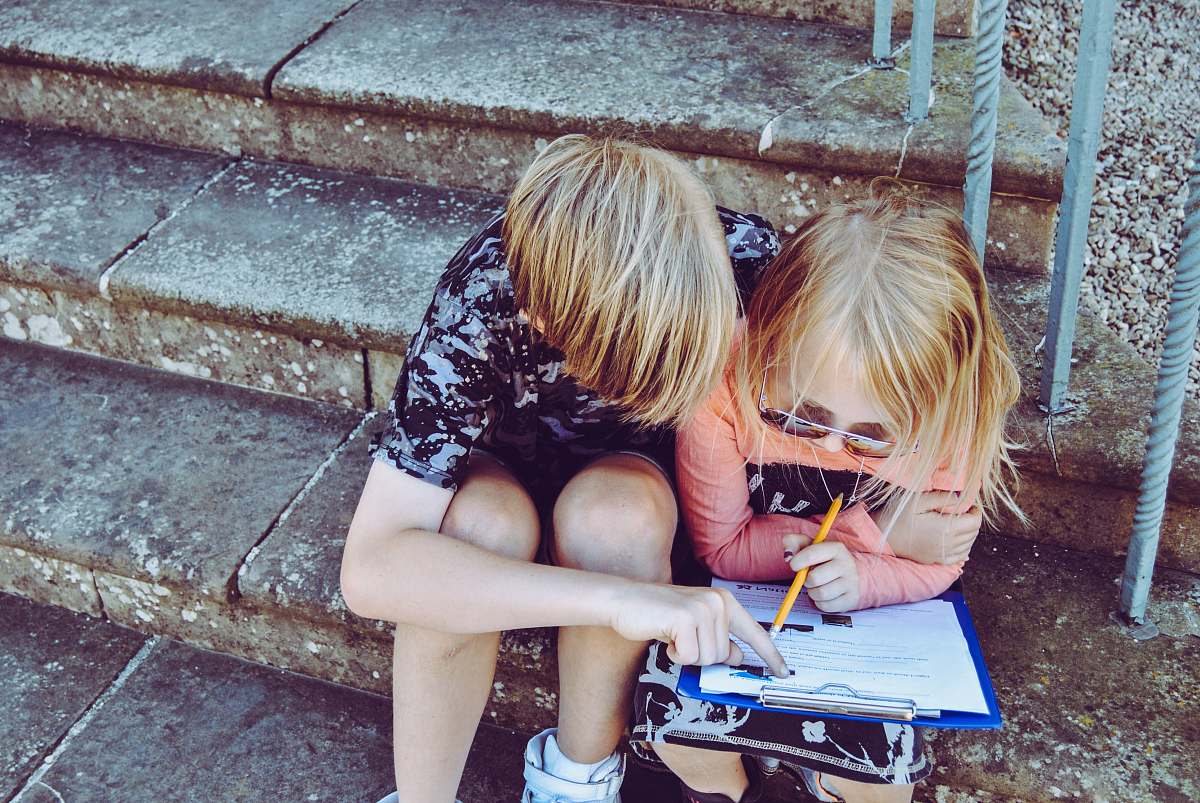 human boy and girl answering questions on white paper people