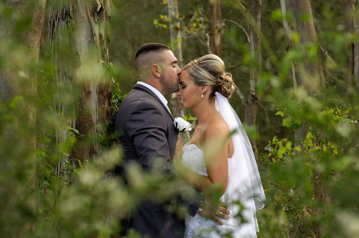 people kissing groom and bride during daytime wedding