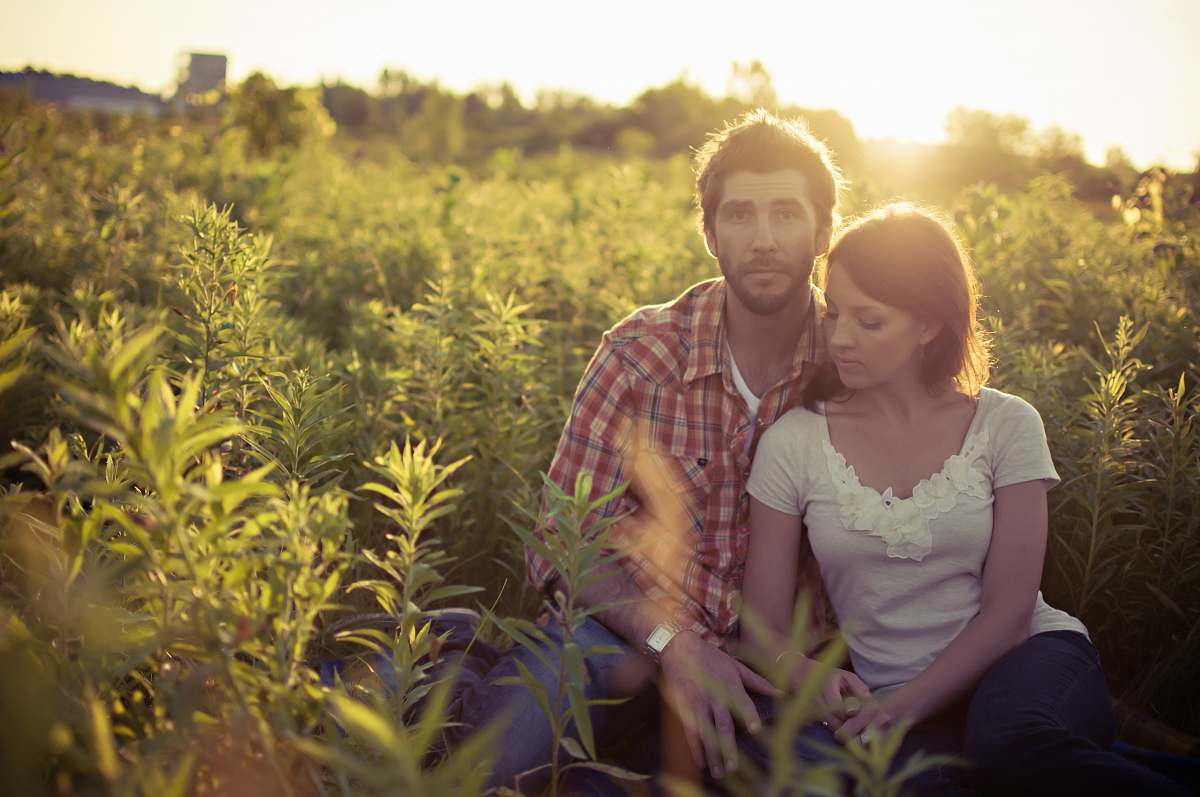 plant man and woman sitting on grass field at daytime human