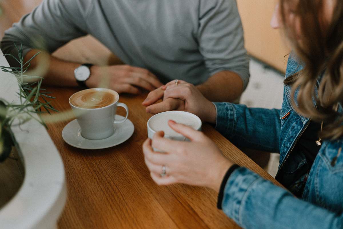 human two mugs with coffee on table cup