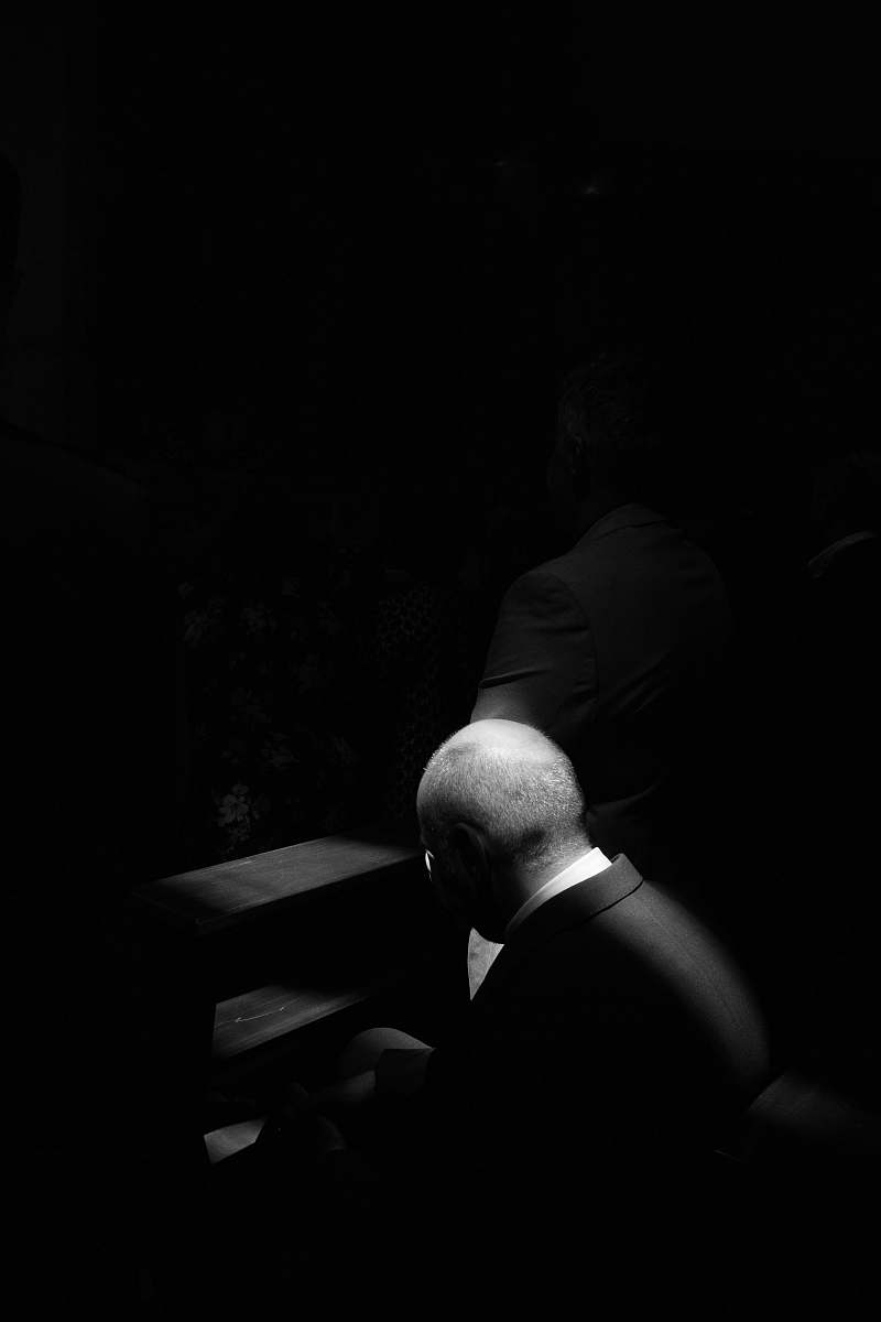 person grayscale photo of man sitting on chair human