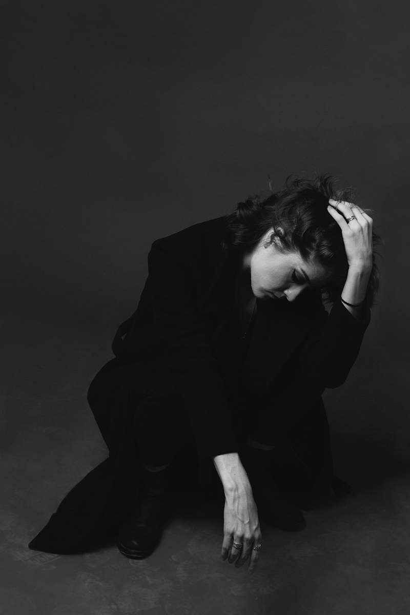 person grayscale photo of woman on squat position human