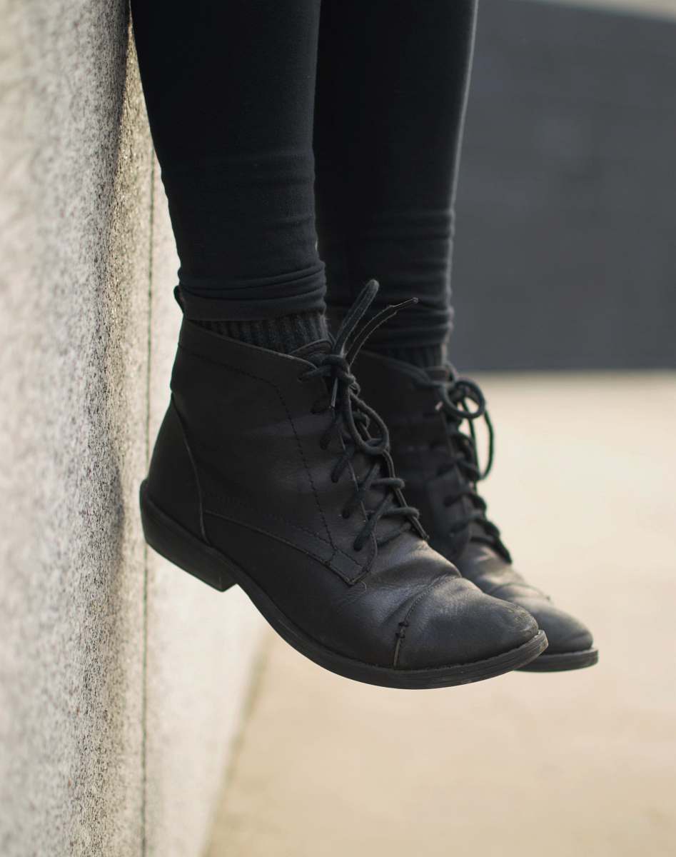 shoe person wearing black lace-up boots clothing