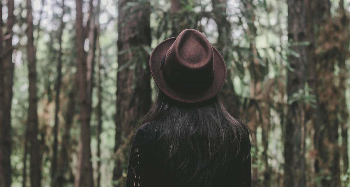 person person wearing hat facing trees hat