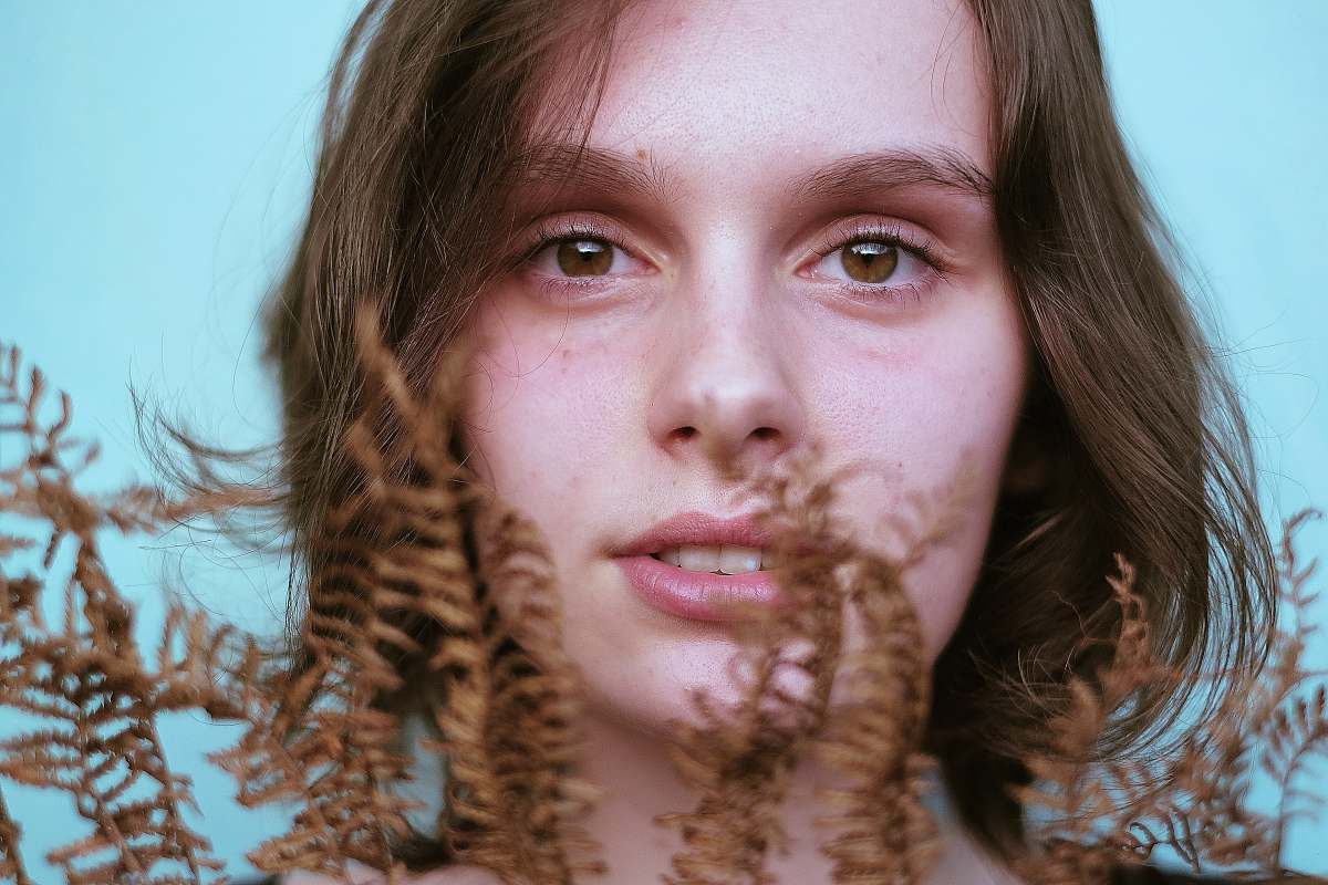 person woman holding brown plants people