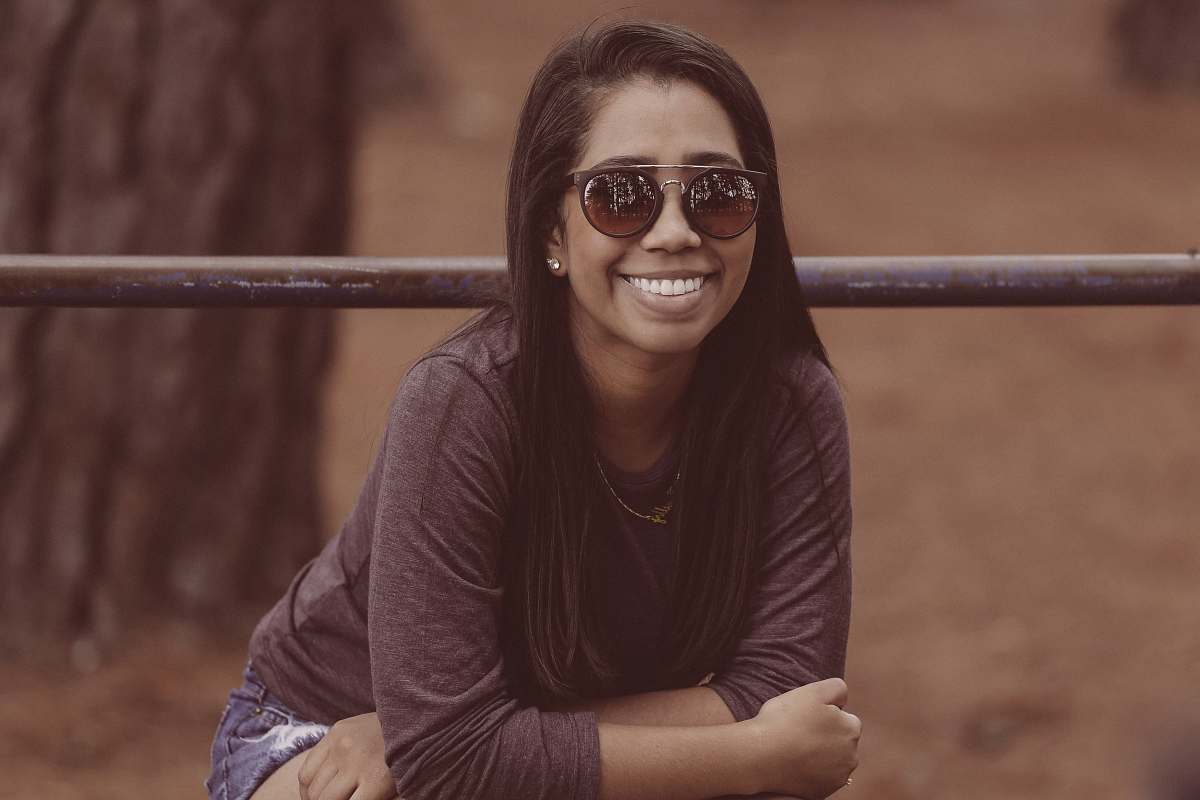 people selective focus photography of woman wearing sunglasses and brown long-sleeved shirt near tree woman