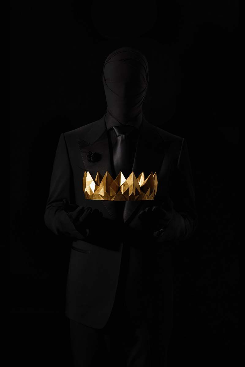 clothing person in black suit jacket holding gold crown human