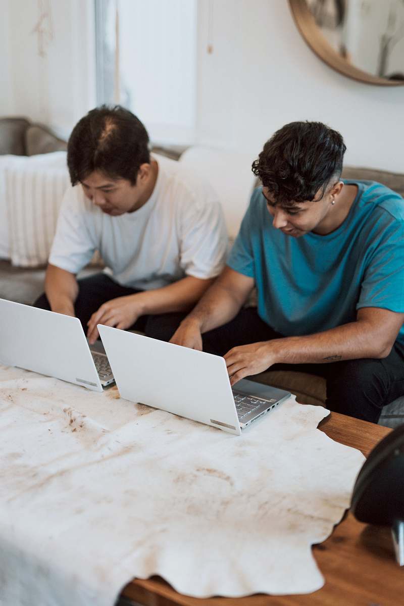 computer man in blue crew neck t-shirt using macbook pc