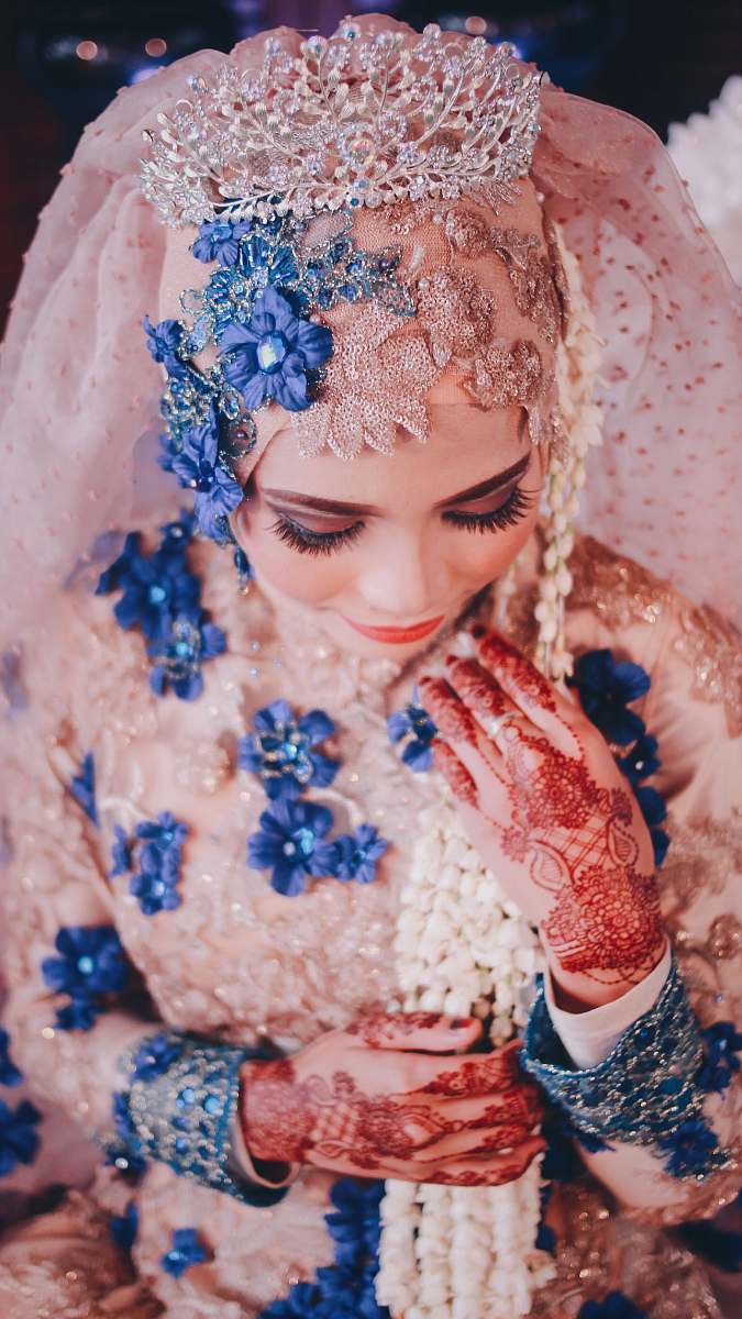 human woman wearing pink and blue floral wedding abaya person