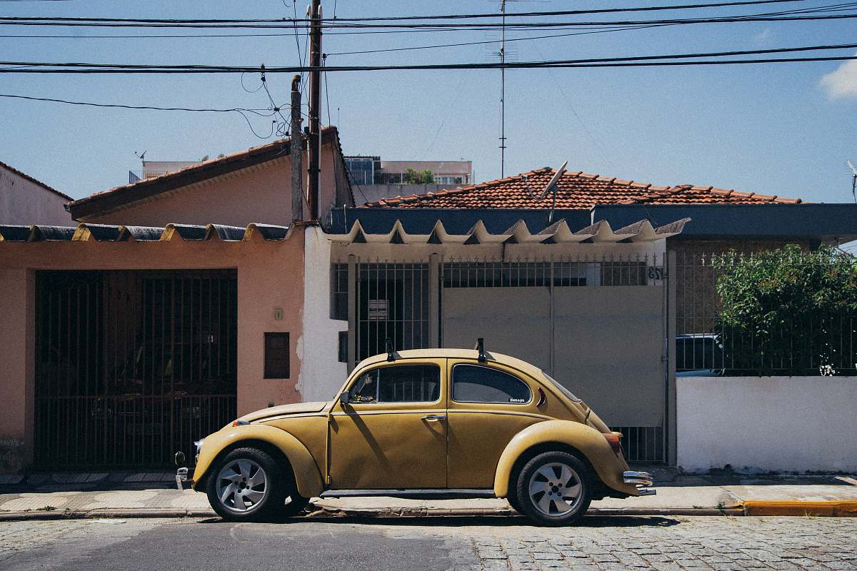 car beige Volskwagen Beetle parked outside house transportation