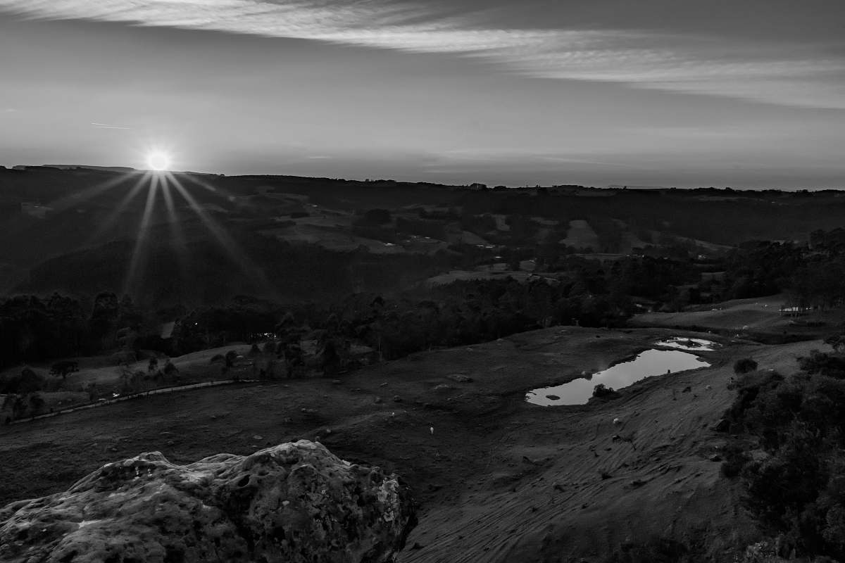 flare grayscale photography of mountain range during daytime light
