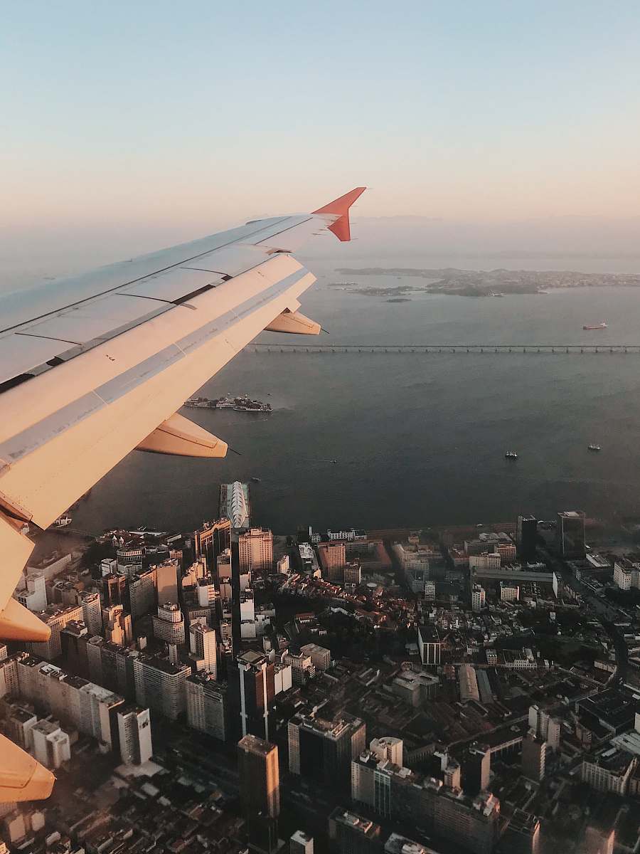 airplane aerial view of plane wings and view of high-rise buildings scenery