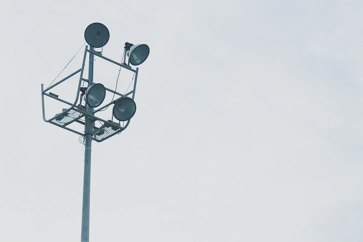light gray megaphones on gray metal post grey
