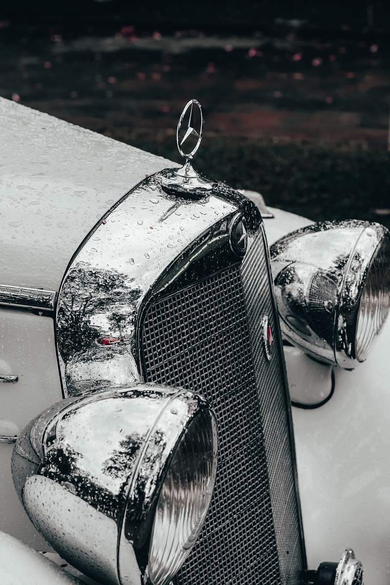 light grayscale photography of classic Mercedes Benz car headlight