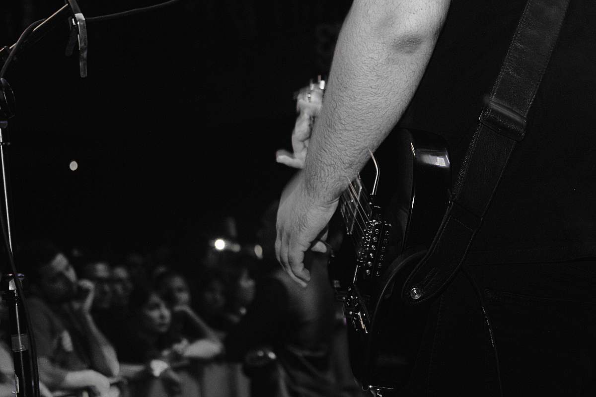 people grayscale photo of person playing guitar black-and-white