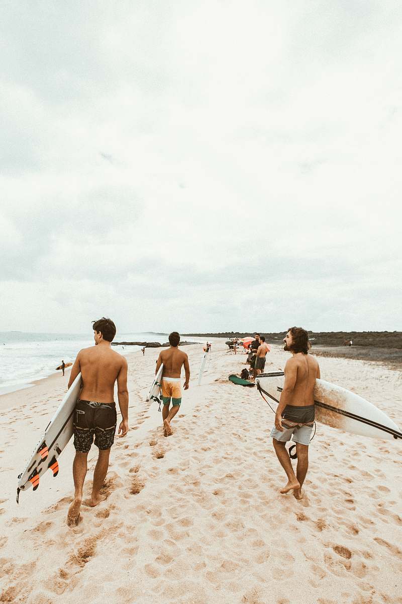 person group of surfer walking on seashore back