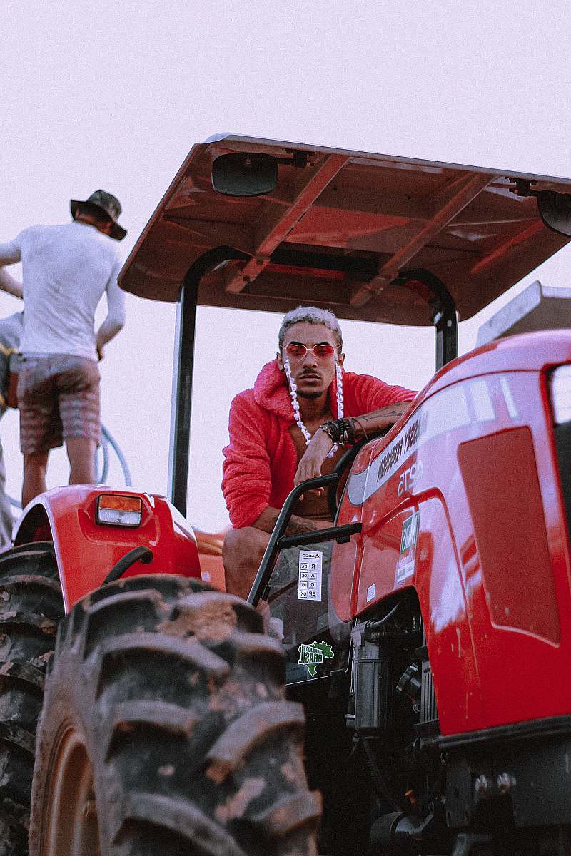 vehicle man riding red tractor tractor
