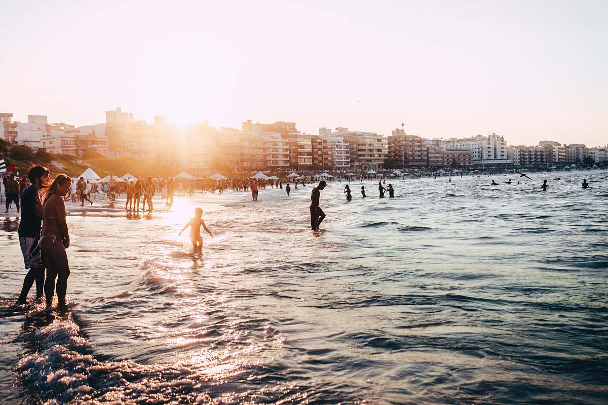 person people standing near body of water at daytime people