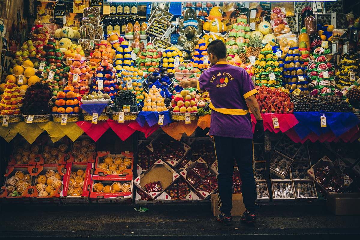 person man standing in front of produce stand human