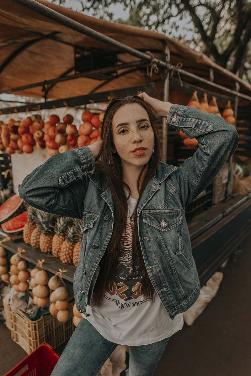person woman standing in front of fruit stand selective focus photography human