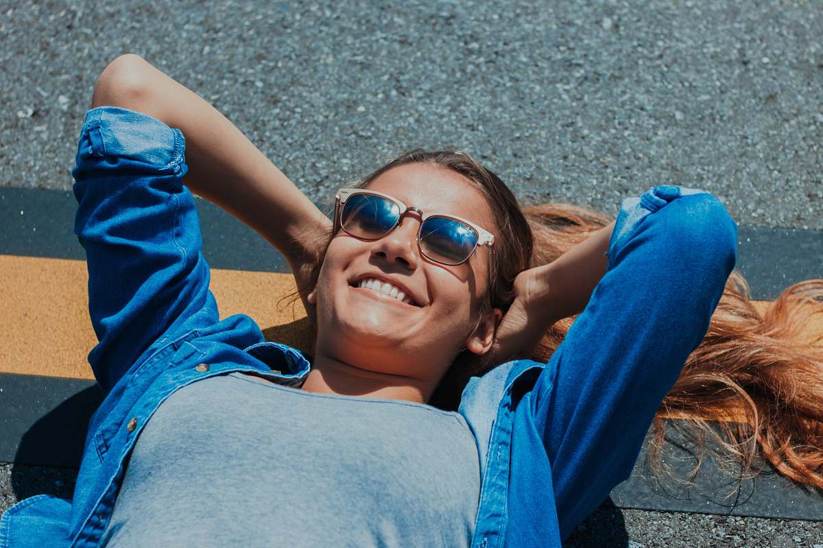 people smiling woman lying on concrete pavement human