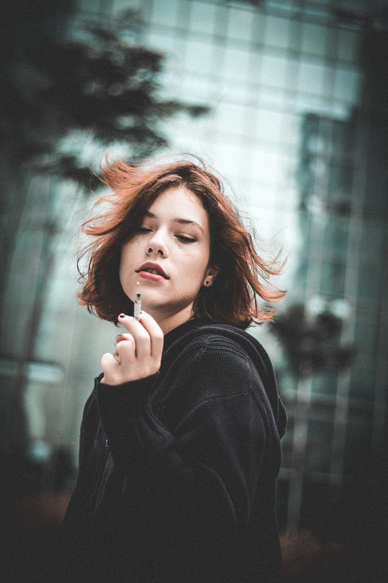 people woman holding cigarette butt human