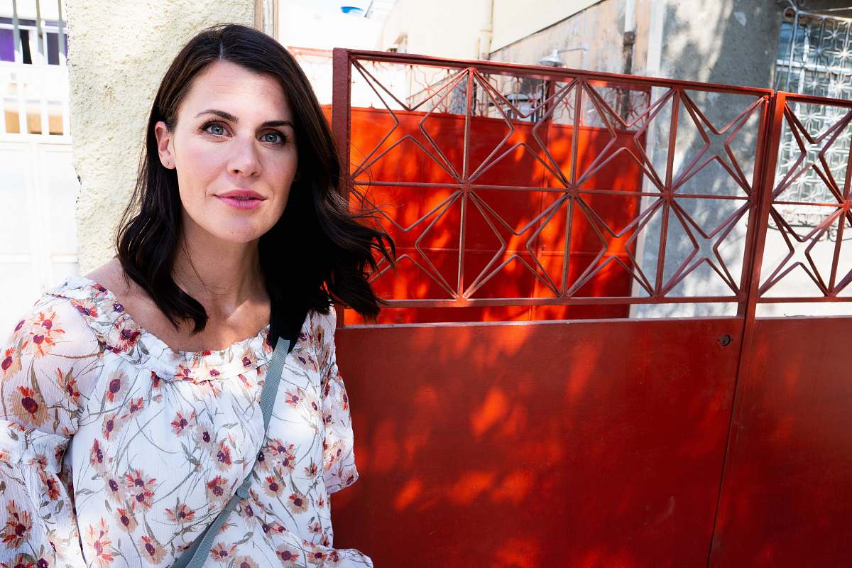 human woman standing near red metal gate rio de janeiro