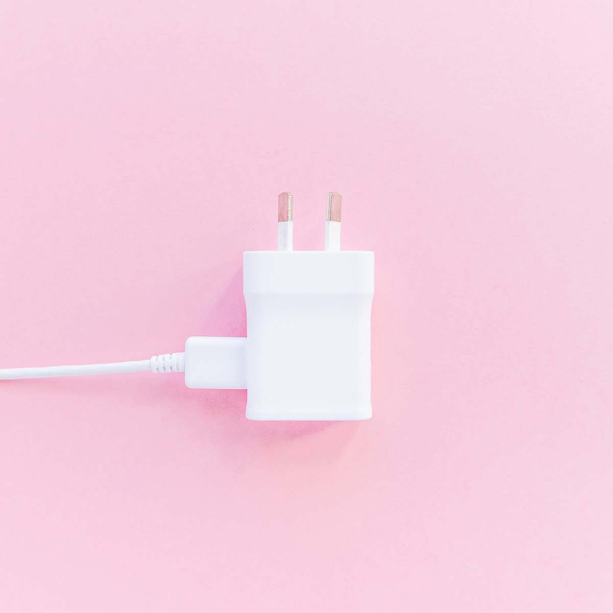 adapter white charger adapter on pink surface plug