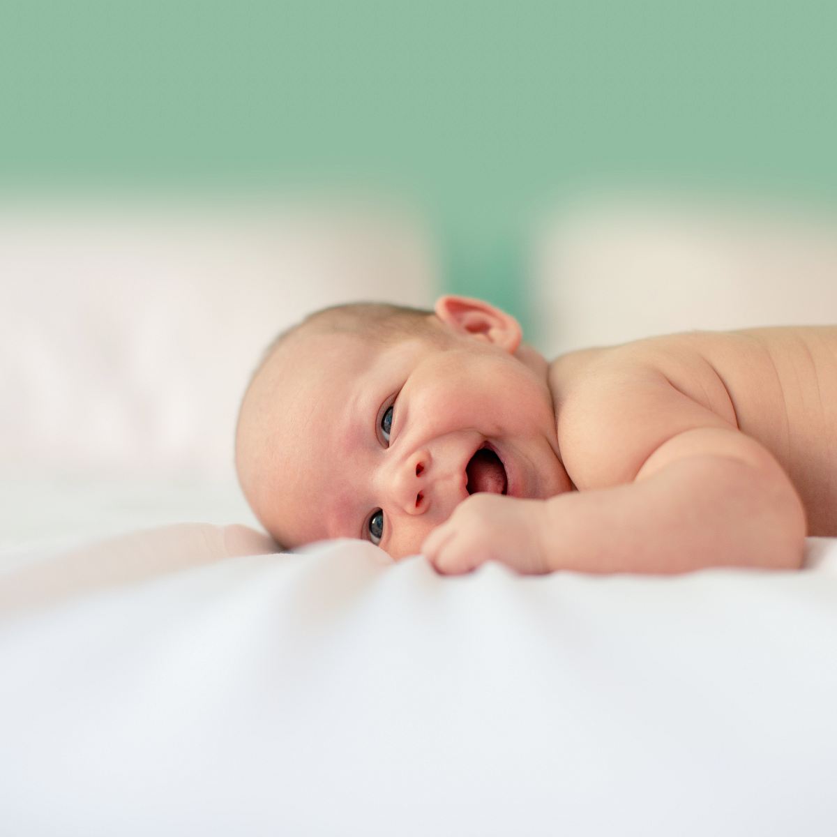 baby lying on fabric cloth
