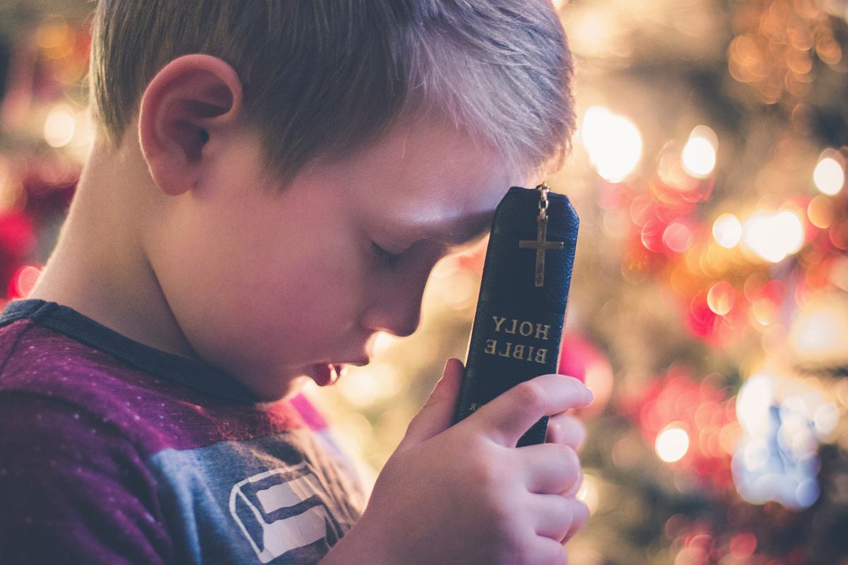 boy holding Holy Bible