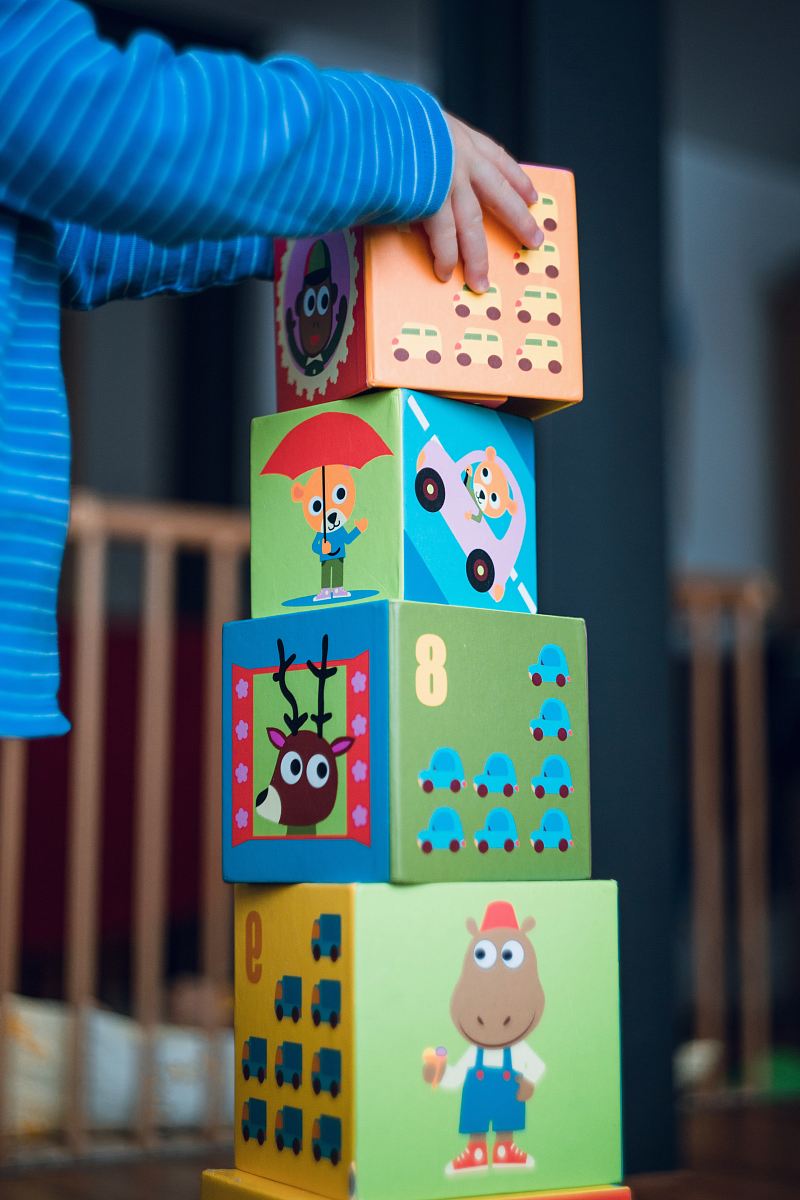 child building an four boxes